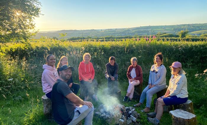 Group of people around a campfire.